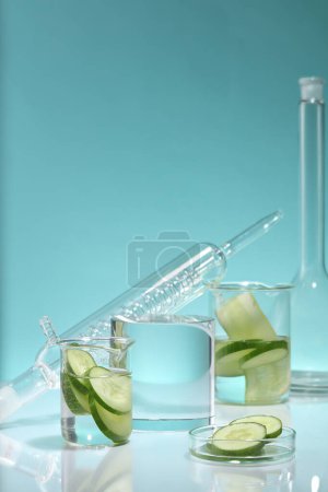 A cylinder podium arranged with some laboratory glassware on mirror table. The high water content in Cucumber (Cucumis sativus) is also thought to reduce symptoms of water retention and puffiness