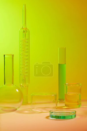 Cylinder podium decorated over a light background. Measuring cylinder, beaker and petri dish with liquid inside. Blank space to display cosmetic product