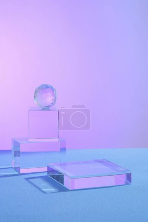 Photo for Over a gradient background, several glass transparent objects and a podium are decorated. Blank space on the podium for beauty and body care product presentation - Royalty Free Image