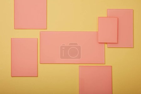 Photo for Several rectangle acrylic sheets in pink color are displayed on a light background. Vacant space on acrylic sheets could be used to display your product - Royalty Free Image