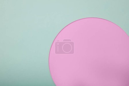 Photo for Minimal scene of a light blue background with a pink acrylic sheet in round shape placed on. Copy space in the left side. Product promotion with vacant space - Royalty Free Image