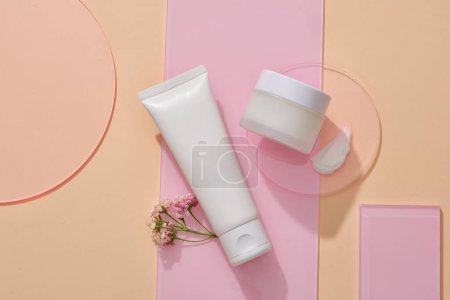 Photo for Several acrylic sheets are arranged with a tube and a round transparent pedestal with unbranded jar and cream texture placed on. Organic product mockup - Royalty Free Image