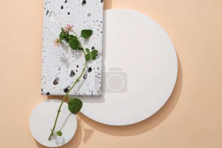 Photo for White podiums in round shape and rectangle stone podium displayed with Lantana camara flowers. Blank space for product presentation. Natural beauty product concept - Royalty Free Image