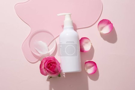 Photo for A mini transparent podium with cream texture displayed with unlabeled pump bottle on geometric acrylic sheet. Rose helps protect against free radical damage - Royalty Free Image