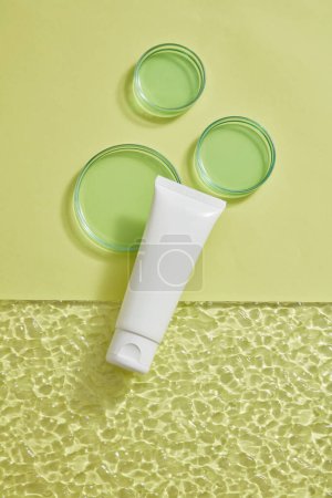 Photo for A white tube without label displayed with petri dishes in different sizes on pastel background. Production of natural skincare products in the laboratory - Royalty Free Image