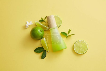 Photo for Composition of a gradient jar, leaves, flowers and Lime slices. Lime (Citrus aurantiifolia) contains a lot of vitamin C to help improve healthy and bright skin - Royalty Free Image