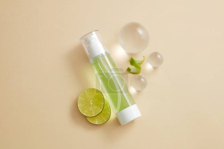 Lime slices, glass balls are displayed with a transparent pump bottle containing green liquid. Essential oil extracted from Lime (Citrus aurantiifolia) is good for your skin