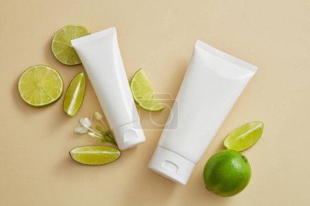 Photo for Two empty label tubes arranged with Lime slices and mini white flowers. Organic beauty product mockup with Lime (Citrus aurantiifolia) extract - Royalty Free Image