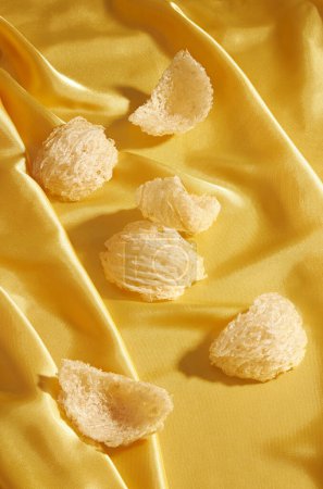 Some edible bird nest decorated on smooth elegant yellow silk cloth texture background. The nutritious value of bird nest is very high