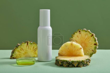 Photo for Pineapple essence contained in a petri dish with empty label bottle and pineapple slices. Pineapple (Ananas comosus) is used in production of cosmetic as ingredient - Royalty Free Image