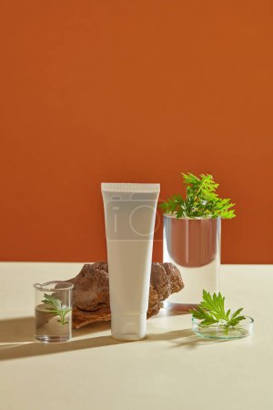 Photo for A cylinder transparent podium, petri dish, beaker of liquid displayed with an empty label tube. Mugwort (Artemisia vulgaris) has many benefits, to have good health and smooth skin - Royalty Free Image