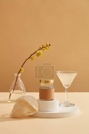 A transparent glass filled with bird nest soup standing next to a jar placed on podium, edible bird nest or swallow nest are also displayed. Product mockup with empty label
