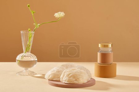 Photo for Some bird nests are placed on a round podium and a glass jar of bird nests soup standing on brown cylinder podium. Bird nest is one kind of beauty food for women. - Royalty Free Image