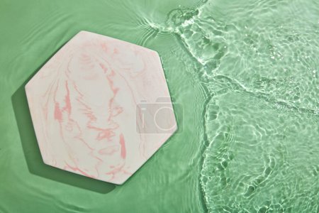 Photo for Hexagon podium on transparent clear green water texture with splashes and waves in sunlight. View from above - Royalty Free Image
