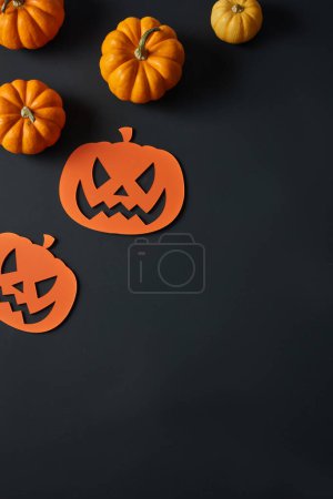 Some orange pumpkins and paper pumpkins arranged in the left corner. Empty space to add product or text.