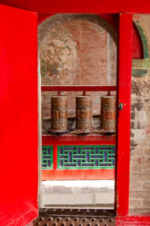 Photo for Prayer wheels behind a gate in a Tibetan temple of the Kumbum Jampaling monastery complex in Xining, China, Asia - Royalty Free Image