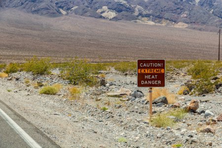Photo for Sign Caution - Extreme Heat - Danger - indicates extreme heat and danger to life, Death Valley National Park, California, USA - Royalty Free Image