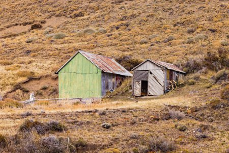 Téléchargez les photos : Une cabane en fer ondulé et une cabane en bois servent de camping et d'abri dans la nature sauvage de Patagonie, Chili - en image libre de droit