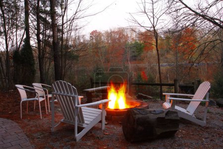 Photo for View of Empty Chairs and Benches Around a Campfire in Autumn - Royalty Free Image