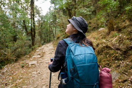 Photo for A young traveller trekking on forest trail , Nepal - Royalty Free Image