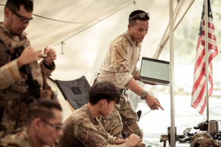 Téléchargez les photos : Soldats en uniforme de camouflage planifiant une opération dans le camp, soldats s'entraînant dans une opération militaire - en image libre de droit