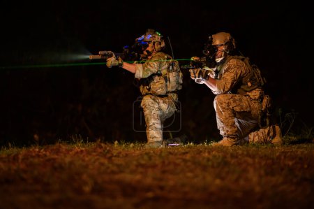 Soldiers ready to fire during Military Operation at night