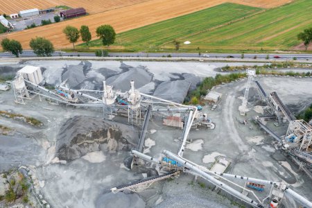 Aerial view of crushing equipment, stone crusher in a quarry, mining equipment for processing and sorting stone, crushed stone, flour