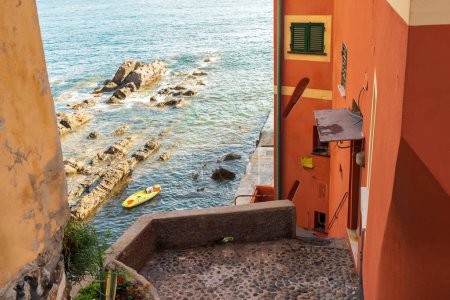 Foto de Fragment of an old European building with a bright colorful wall near the sea in Boccadasse, Italy at summer - Imagen libre de derechos