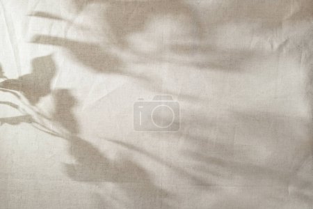 Photo for Abstract sun light shadow silhouette on a beige textile, aesthetic floral background, copy space - Royalty Free Image