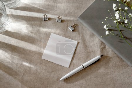Foto de Blank paper card and sunlight shadows on a table, minimalist spring aesthetic workspace - Imagen libre de derechos