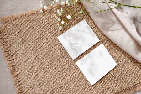 Photo for Aesthetic minimalist business branding template, two blank paper cards on a warm beige natural jute napkin background, flat lay, copy space - Royalty Free Image