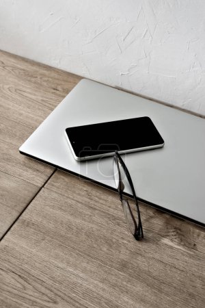 Photo for Minimalist business brand concept, laptop, mobile phone and glasses on a beige wooden table, aesthetic home office workspace, copy space - Royalty Free Image