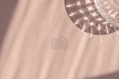 Téléchargez les photos : Fond beige pastel neutre clair avec des ombres de soleil abstraites esthétiques et un motif de réflexion en verre cristal. Design élégant d'invitation de mariage, carte de vœux, modèle de marque d'affaires. - en image libre de droit