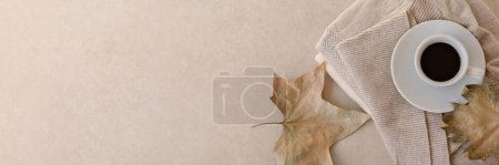 Photo for Aesthetic minimalist long horizontal neutral beige autumn banner with copy space. Coffee cup with hot drink, light brown dried fall leaves, woolen knitted clothes on pastel background. - Royalty Free Image