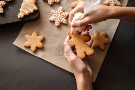 Photo for Christmas gingerbread cookie decoration with sugar icing. Soft selective focus, lifestyle. - Royalty Free Image