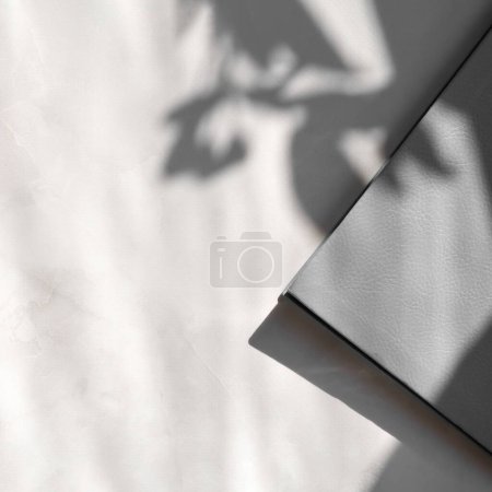 Photo for Aesthetic floral sunlight shadows on neutral marble table background and gray notebook cover, elegant minimal business branding template for social media blog. - Royalty Free Image