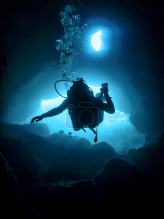 Scuba Diver Silhouette in Underwater Cave