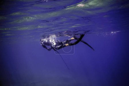 Spearfisher Swims on the Surface of the Sea, Spearfishing
