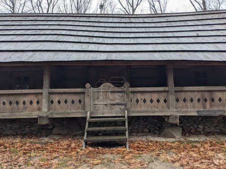 Foto de The open-air museum of traditional wooden architecture in the national park in Ukraine, wooden house porch  view - Imagen libre de derechos