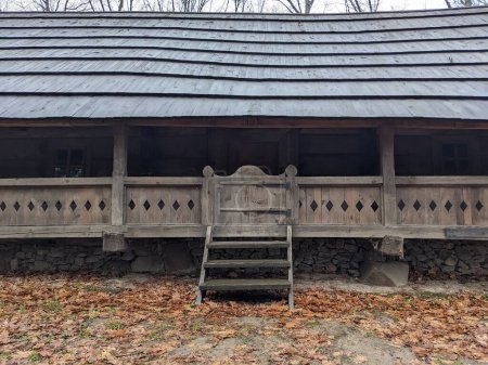 Foto de The open-air museum of traditional wooden architecture in the national park in Ukraine, wooden house porch  view - Imagen libre de derechos