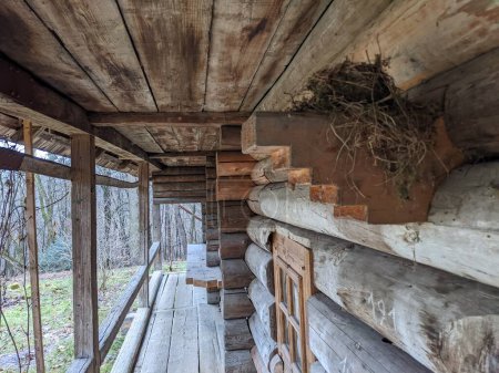 Photo for The open-air museum of traditional wooden architecture in the national park in Ukraine, nest view on the wooden house porch - Royalty Free Image