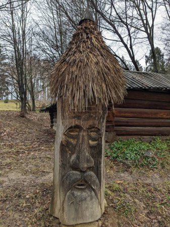 Photo for The open-air museum of traditional wooden architecture in the national park in Ukraine, wooden Slavic statue view - Royalty Free Image