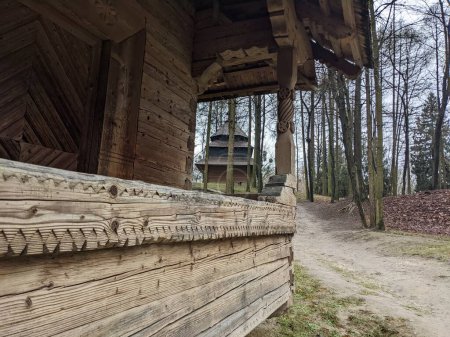 Photo for The open-air museum of traditional wooden architecture in the national park in Ukraine, wooden house porch view - Royalty Free Image