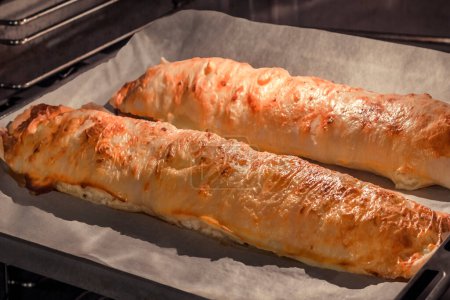 Téléchargez les photos : Traditional Serbian Cheese Roll Pie rolls baked in oven - en image libre de droit
