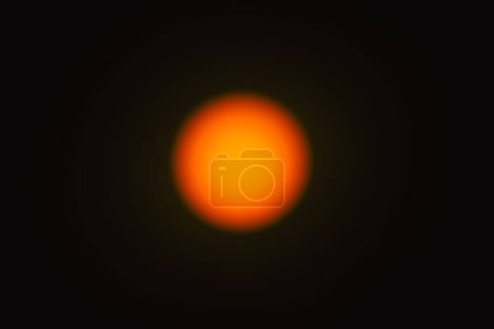 Photo for The solar disk photographed with a telephoto lens. As a result of using an optical filter, a warm color of the sun disk was obtained and a blurred effect was applied. - Royalty Free Image