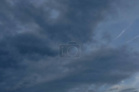 Photo for The sky is covered with dark, wavy clouds promising rain. - Royalty Free Image