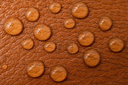 Photo for Round water drops on brown leather texture, soft focus close up pattern - Royalty Free Image