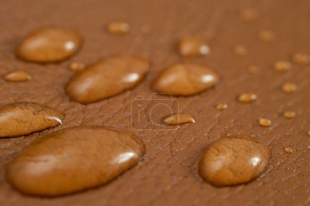 Photo for Round water drops on brown leather texture, side view, soft focus macro pattern - Royalty Free Image