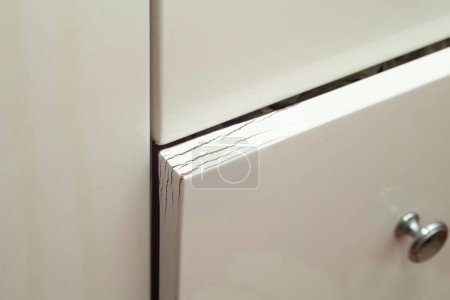 Téléchargez les photos : Damaged door from bathroom furniture, soft focus close up - en image libre de droit
