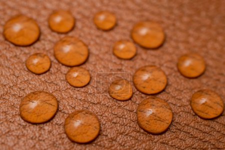 Photo for Round water drops on brown leather texture, soft focus close up pattern - Royalty Free Image